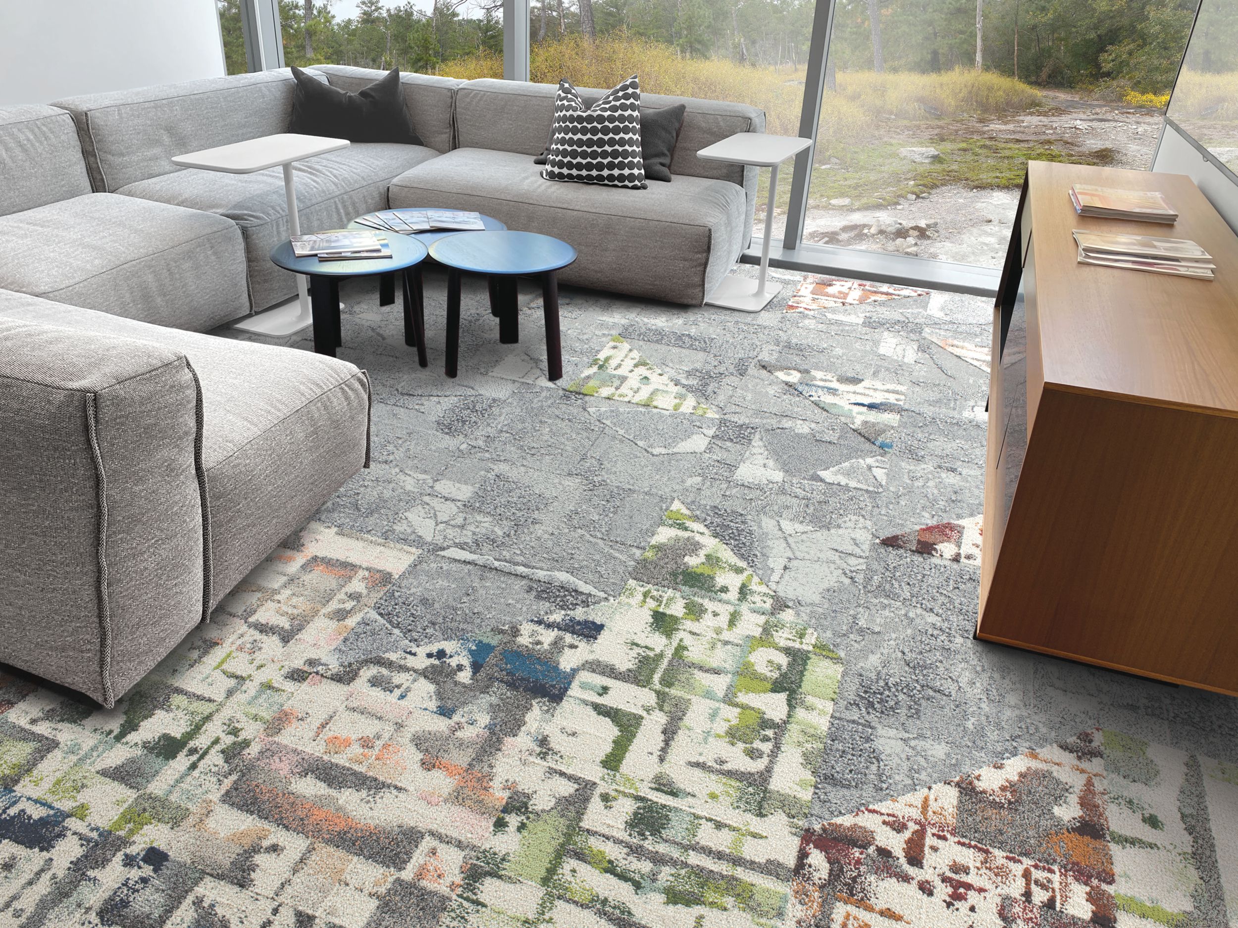 Interface Panola Mountain and Mountain Rock carpet tile in living room area with grey couch and blue center tables imagen número 4